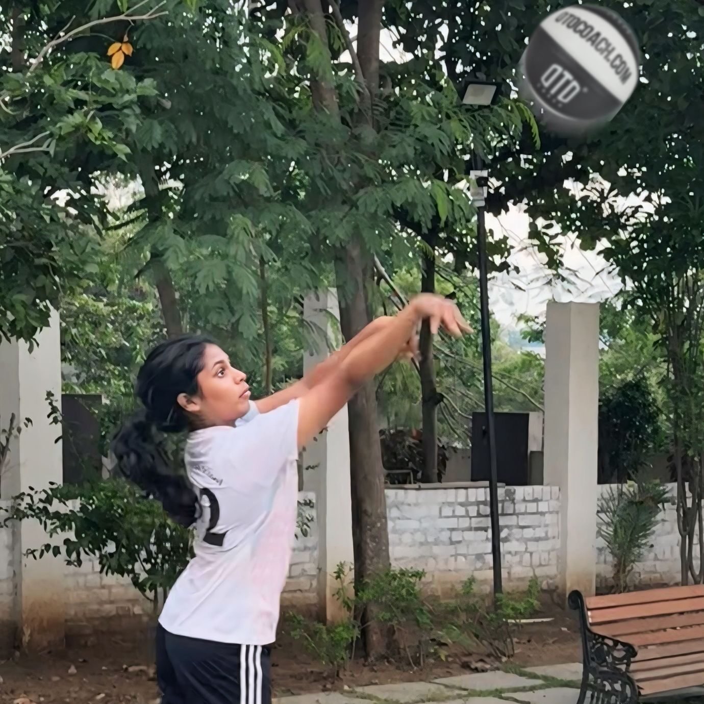 Seshvika Chinimilli shooting a basketball during a coaching session at OTO COACH, celebrating one year of training, confidence, and winning multiple best player awards.